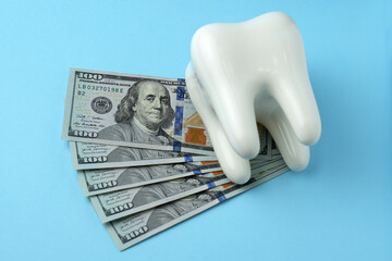 Dollar money bills and tooth model on a bluebackgound with copy space - 794896994