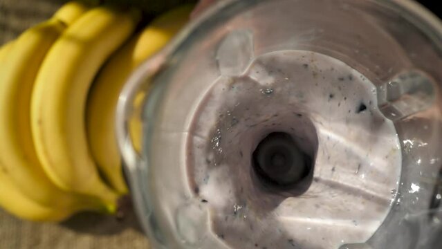 the process of mixing a fruit cocktail with the addition of milk and berries in a blender and make a nutritious smoothie yourself. Alternative for breakfast or dinner. Diet meal replacement