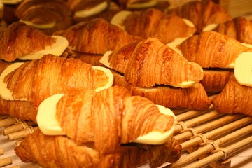 A buttery, flaky pastry originating from France, croissant is beloved for its delicate layers and rich taste. - obrazy, fototapety, plakaty