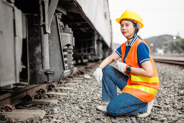 portrait train locomotive engineer women worker. Happy Asian young teen smiling work at train station train track locomotive service maintenance. - 794912917