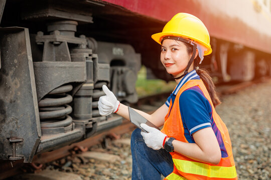 happy engineer women worker check service maintenance train wheel suspension confirm thumbs up good condition