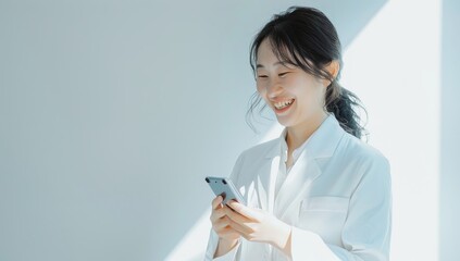 A smiling Japanese business woman holding her smartphone. asian businesswoman on white background