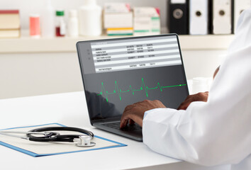 Cardiologist working with laptop at office. Health care concept