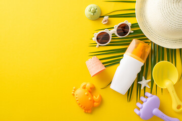 Bright summer day essentials lay flat on the yellow background, featuring a straw hat, sunglasses, sunscreen, and kid's beach toys