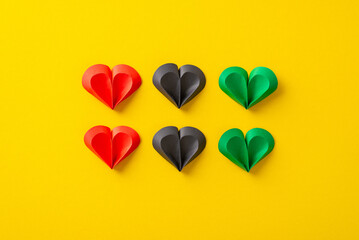 Liberation homage: of hearts in red, green, black on yellow canvas, representing Juneteenth's...