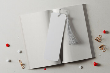 Bookmark with tassel on an open book mockup. 3D rendering