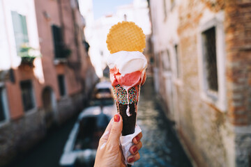 Delicious gelato or ice cream in waffle cone in Venice Italy. - 794923714