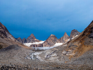 View of the Niialigaq mountain range in East Greenland with an indigo-colored sky.