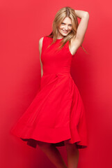 Studio, dance and portrait of woman with dress for fashion, stylish event and feminine confidence. Female person, happy and smile with pose for freedom, glamour and luxury clothes on red background