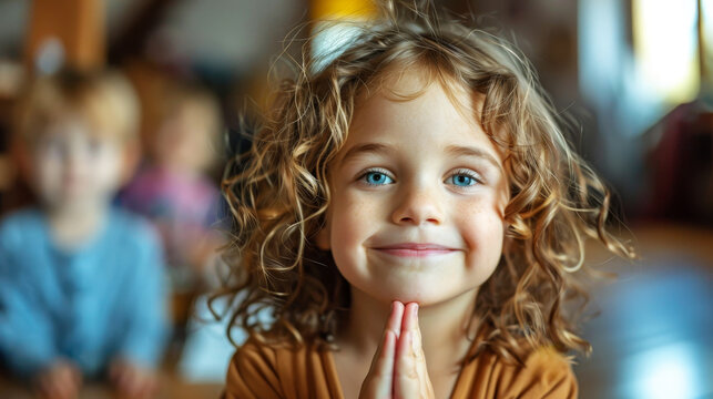 Joyful curly-haired young girl with sparkling eyes in classroom setting
