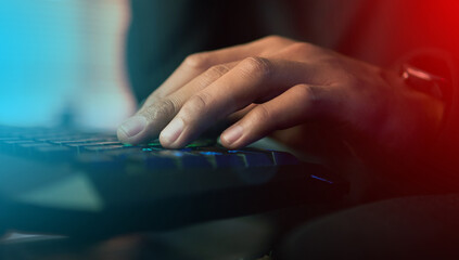 Hands, typing and keyboard for esports, online and gaming with person at home in dark room....