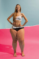 Smiling young woman with slim, relief upper body and fat legs with cellulite on the bottom....