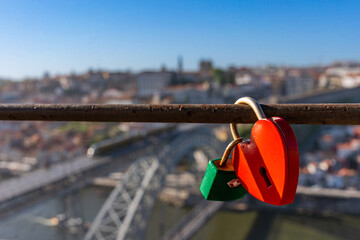Red and green padlocks with views of the city