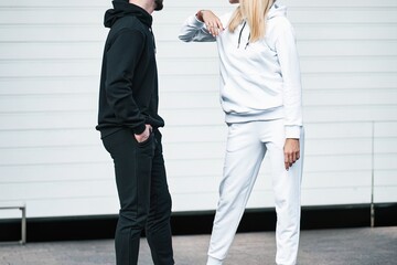 Woman and Man wear a sweatshirt hoodie. Isolated close-up of streetwear apparel. Hoodies mockup.