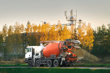 Industrial Machinery at Work as Cement Mixer Truck Heads to Construction Zone