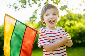 Cute boy holding tricolor Lithuanian flag on Lithuanian Statehood Day, Vilnius, Lithuania - 794963506