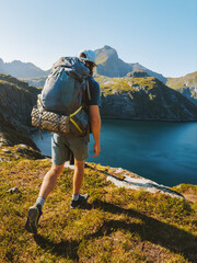Man hiking solo with backpack in Norway mountains travel outdoor active summer vacations healthy lifestyle extreme sports, traveler exploring Lofoten islands