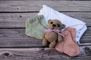 Small gift for newborn baby, soft knitted socks and bodysuit