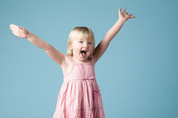 Studio, child or girl excited with scream for surprise, happy or isolated on blue background. Model, backdrop or kid for announcement with motor skills for wow, omg or shocked with mind blown