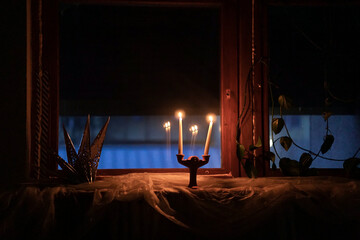 Candle light in the dark room at night - obrazy, fototapety, plakaty
