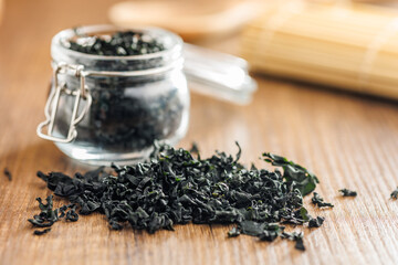 Dried wakame seaweed on wooden table. - 794992741
