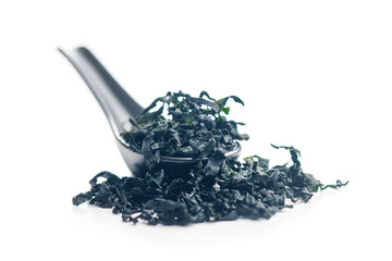 Dried wakame seaweed in spoon isolated on white background. - 794993916