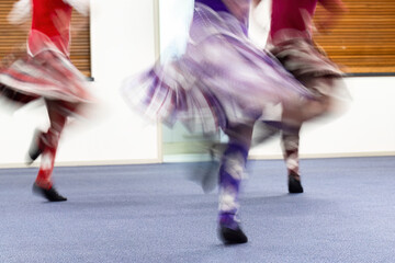 Young girls enjoying Highland dancing at a dance club. Motion blur of beautiful flying skirts captured in camera by using slow shutter speed. - 794998171