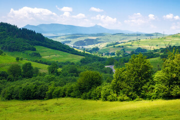 picturesque landscape of the rural valley and farmland scenery of ukraine. village and mountains in...