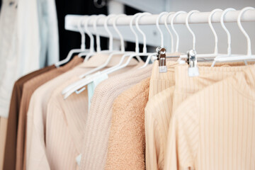 Retail, hanger and clothing in store, fashion and boutique for sale for designer garments. Rack, fabric and casual wardrobe outfit choice, rail and purchase or shop for pastel discount material