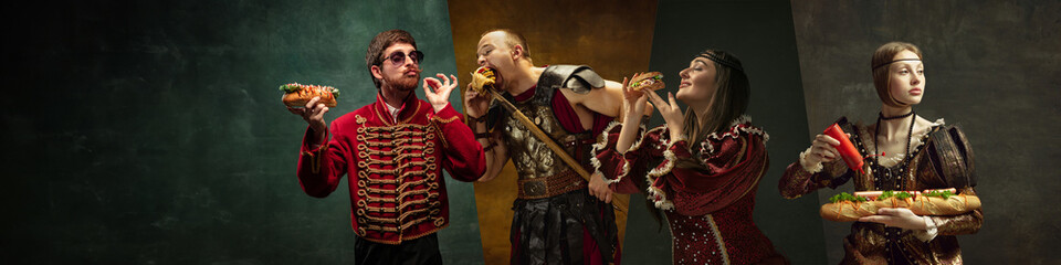 Medieval people, royal persons, warriors eating delicious burgers and hot dog against dark green...