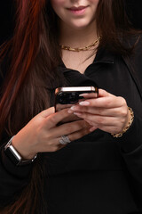 Close up of women's hands holding cell telephone with blank copy space scree for your advertising text message or promotional content. No Face