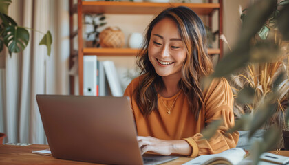 Smiling Woman Using Laptop at Home Indicating the Joy of Remote Working
