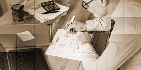 Mature businessman working on documents, geometric pattern