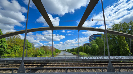 A composite material bridge spans train tracks under a clear blue sky Mittellandkanal Hanover cargo...