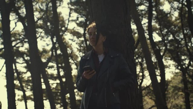 Young female in the forest alone. Sunny day. cinematic.