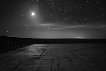 empty concrete floor on a rooftop bathed in the soft light of the moon and stars 