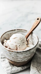 food photography of chocolate ice cream in a ceramic bowl with a wooden spoon against a white background, with a simple, minimalist, clean style