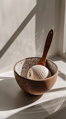 food photography of chocolate ice cream in a ceramic bowl with a wooden spoon against a white background, with a simple, minimalist, clean style - 795056317