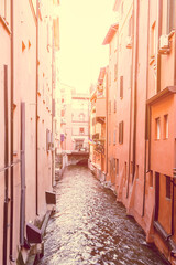 A nostalgic glimpse into Bologna past, the Canale delle Moline meanders between faded walls, a secret waterway in a city rich with history - obrazy, fototapety, plakaty