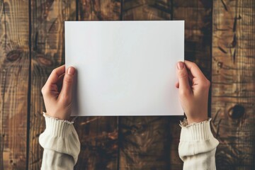 Person holding a blank white paper - obrazy, fototapety, plakaty