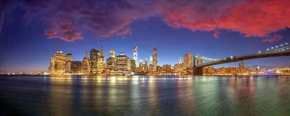New York City night lights. Lower Manhattan and Brooklyn Bridge panorama from Brooklyn Bridge Park