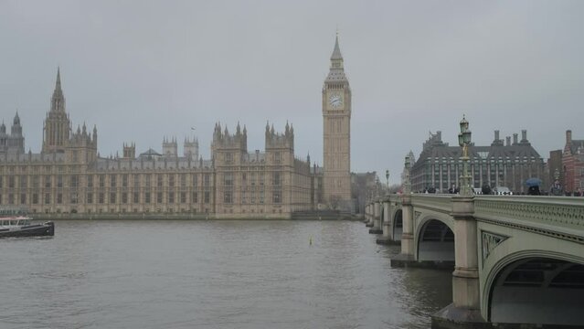 The Thames River in London with Westminster Bridge, Big Ben and the Houses of Parliament and and iconic AEC Routemaster red double-decker buses in London, United Kingdom