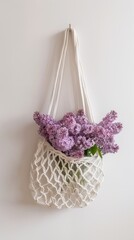 A net bag with lilac hanging on the wall, - 795076352