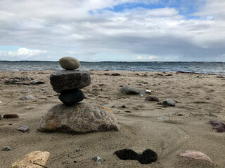 Stacked balancing stones on a sandy beach