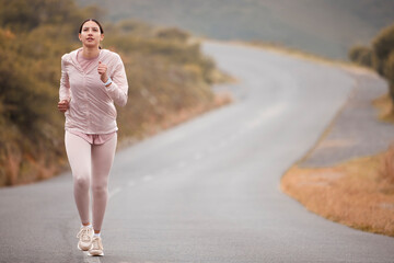 Road, fitness and woman running for exercise in nature for race, competition or marathon training....