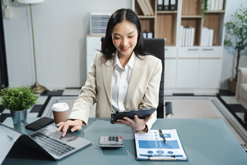 Business woman or financial data analysts working with smartphone and laptop computers and data...