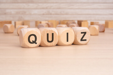 short word english text QUIZ on a wooden cubes with wooden background