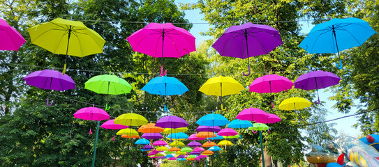 Fototapeta na wymiar An alley in the city park. An alley with colorful umbrellas