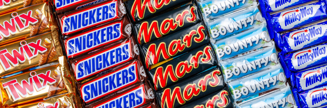 Products of Mars Inc. company like Snickers, Twix, Milky Way and Bounty chocolate bars panorama background