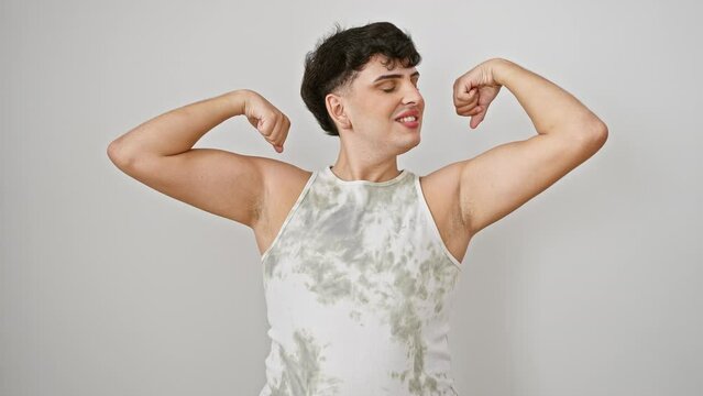 Flaunting fit, young man delightedly showing off toned muscles in sleeveless t-shirt, embracing healthy lifestyle. isolated on sparkling white background.